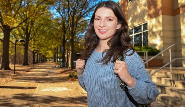 A woman stands on ODU’s campus.